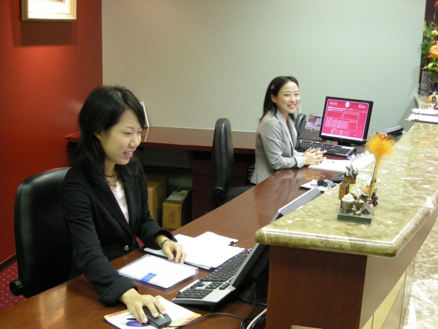 Receptionists working at a front desk
