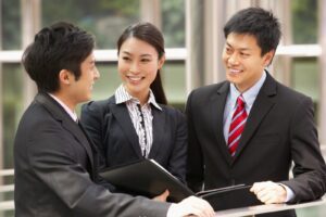Three people in suits and ties are talking.